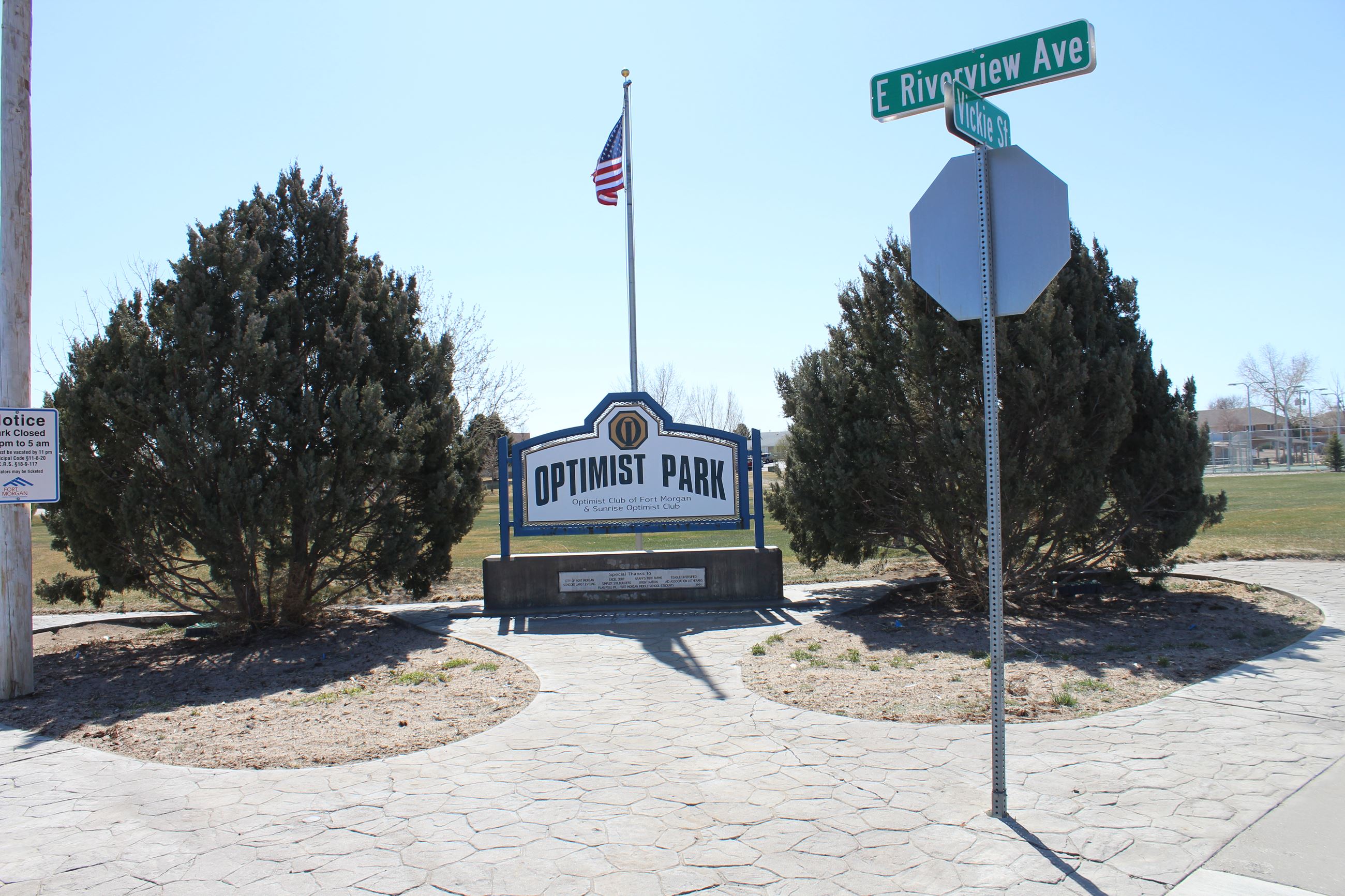 Image of sign and flag pole at Optimus Park